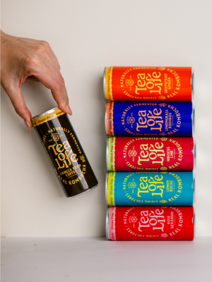 Tea of Life REAL kombucha cans in six flavours stacked on a white surface